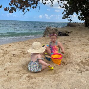 Girls on beach with sand bucket